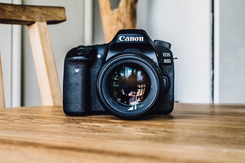 Canon EOS 80D DSLR camera on a wooden table